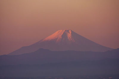 View of volcanic mountain against sky during sunset