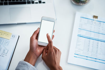 Cropped hands of woman using mobile phone