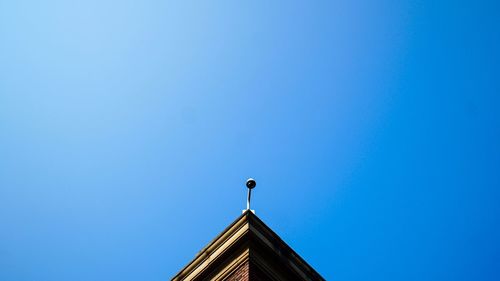 Low angle view of bird against clear blue sky