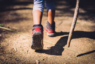 Low section of child walking on footpath