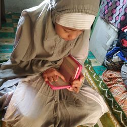 High angle view of girl reading book at home