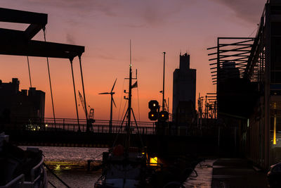 Silhouette city against sky during sunset