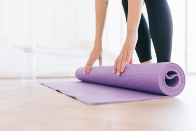 Low section of woman doing yoga on table