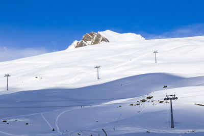 Georgian ski resort in gudauri. snowy mountains, daytime and sunlight.