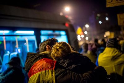 People in illuminated city at night