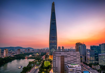 Buildings in city against sky during sunset