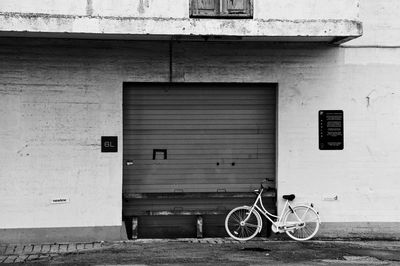 Bicycle parked on wall of building
