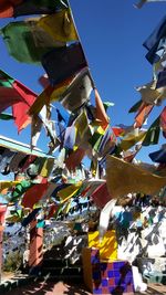 Low angle view of flags hanging against sky