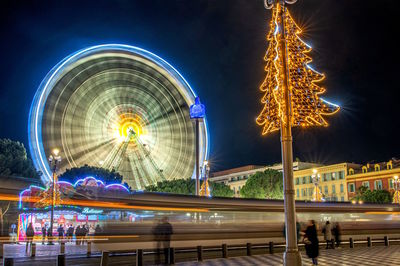 Illuminated ferris wheel at night