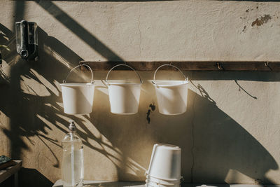 High angle view of glasses on floor against wall