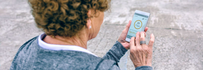Rear view of man holding camera