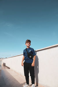 Portrait of young man standing against clear sky
