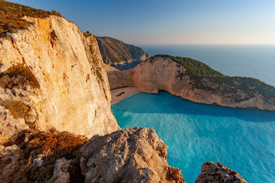 Rock formations by sea against sky