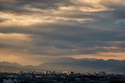 Aerial view of townscape against sky at sunset