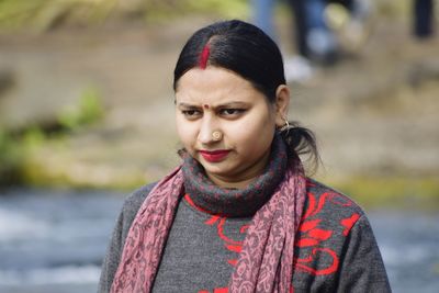 Portrait of young woman standing outdoors