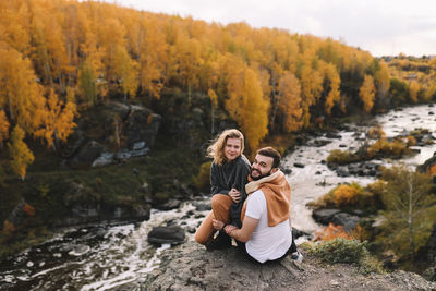 Mother and daughter in park during autumn