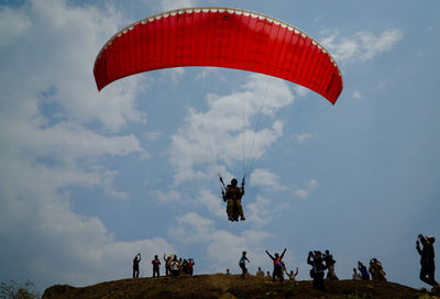 People paragliding against sky