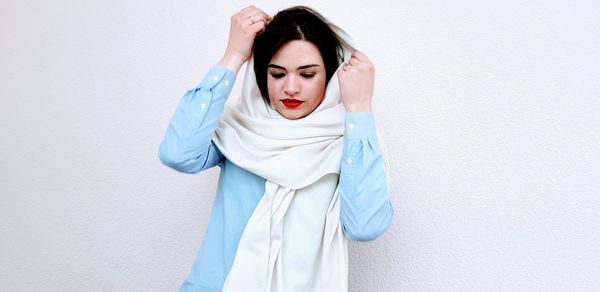 Woman wearing scarf against white background