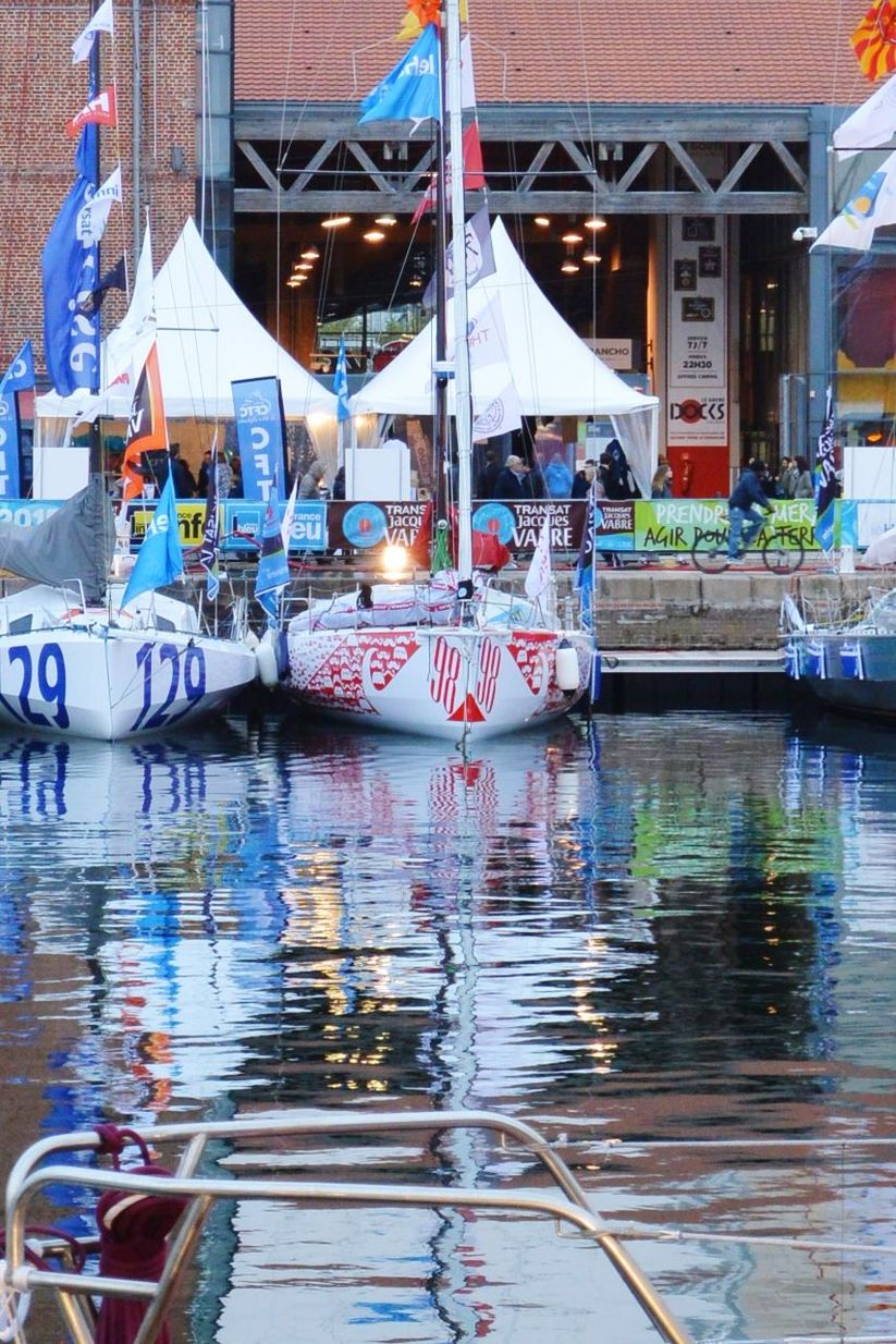 water, built structure, architecture, building exterior, reflection, waterfront, canal, multi colored, nautical vessel, day, outdoors, hanging, building, transportation, moored, boat, rippled, graffiti, no people, city