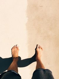 Low section of people standing on beach