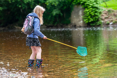 Girl standing against lake