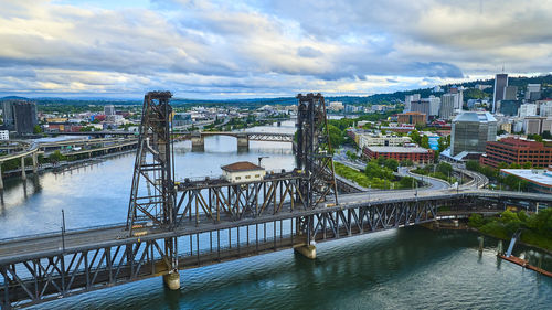 High angle view of bridge over river in city against sky