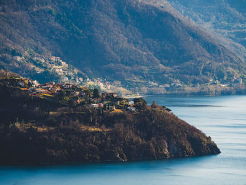 Scenic view of sea and mountains against sky