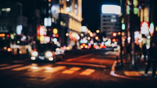 Defocused image of traffic on city street at night