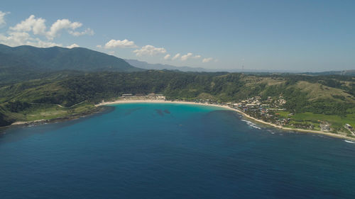 Aerial view of beautiful tropical beach with turquoise water in blue lagoon, pagudpud, philippines. 