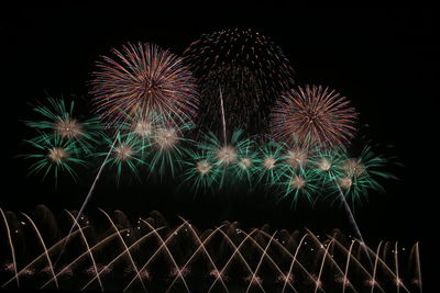 Low angle view of firework display at night