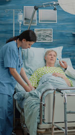 Nurse examining senior patient at clinic