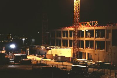 Illuminated commercial dock against sky at night