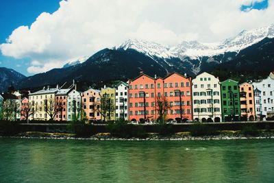 River by buildings against sky in city