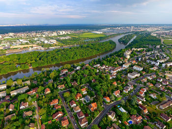 High angle view of townscape by sea against sky