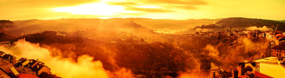 Sunrise with fog over the veliko tarnovo city and tsarevets fortress,, bulgaria, sepia filter