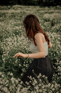 Side view of woman standing on field