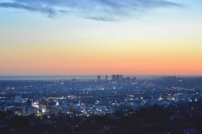 High angle view of illuminated cityscape against sky during sunset