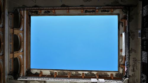 Low angle view of old building against blue sky