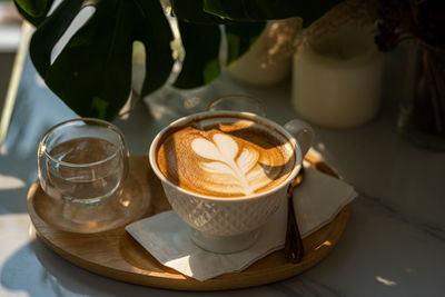 Cup of coffee served on table