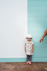 Girl standing against wall