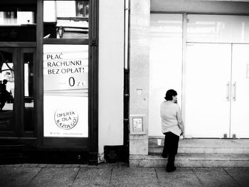 Full length of woman standing by railing