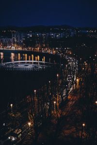 High angle view of illuminated bridge over river at night