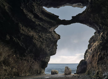 Scenic view of sea seen through cave