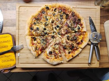 High angle view of pizza on cutting board