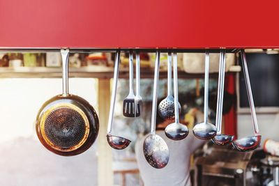 Close-up of cooking utensils hanging in kitchen at home