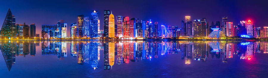 Illuminated modern buildings in city at night