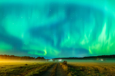 Scenic view of field against sky at night