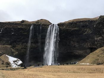 Scenic view of waterfall against sky