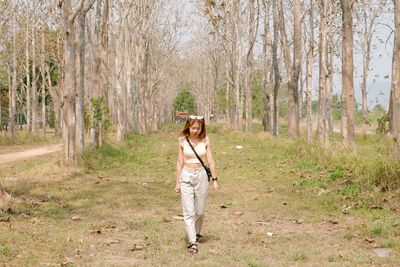 Full length of girl standing in forest