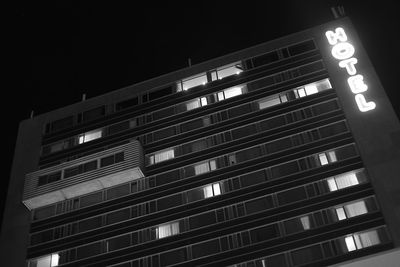 Low angle view of illuminated building against sky at night